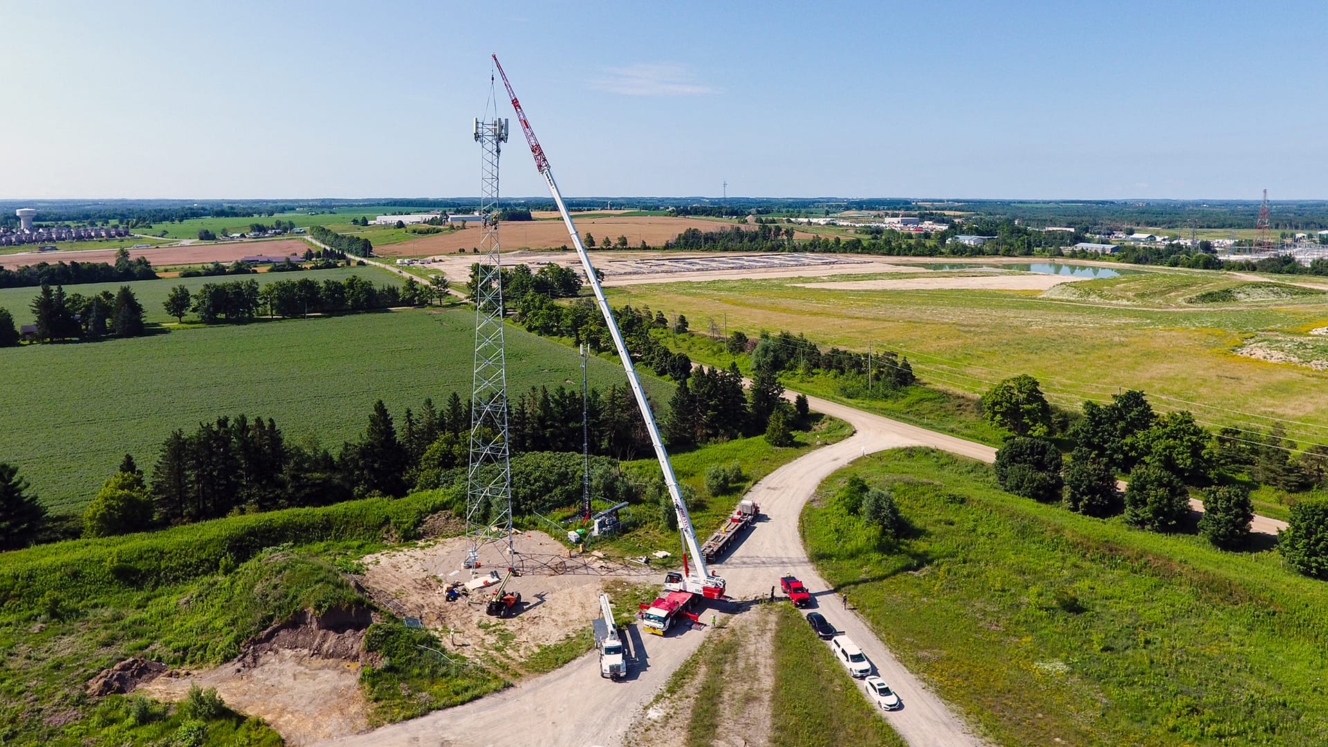 drone shot of 175AT lifting section of cell tower
